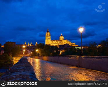 Salamanca skyline sunset and roman bridge over Tormes river in Spain