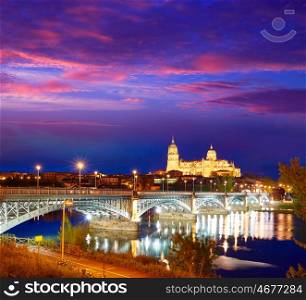 Salamanca skyline sunset in Enrique Estevan bridge over Tormes river in Spain
