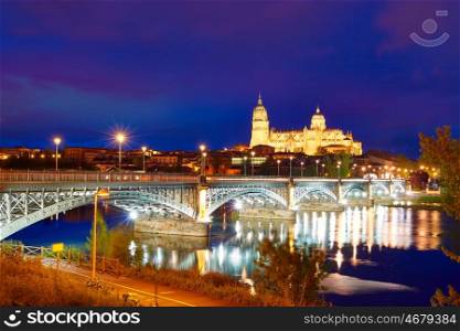 Salamanca skyline sunset in Enrique Estevan bridge over Tormes river in Spain