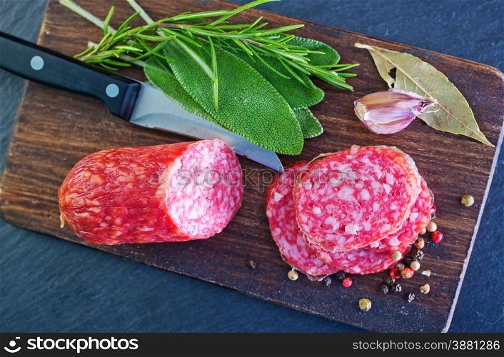 salami and knife, salami on black table