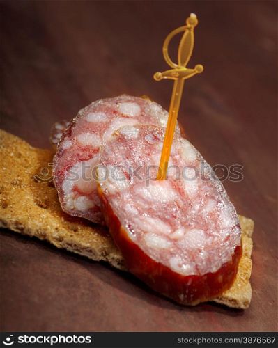 Salami canape. close up with washed away by back background