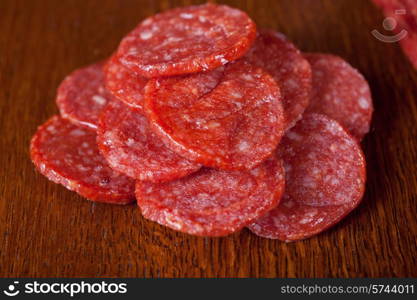 salami closeup at wooden table . salami