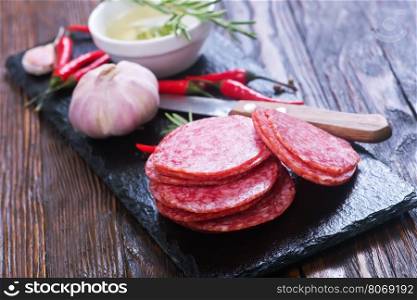 salami on board and on a table