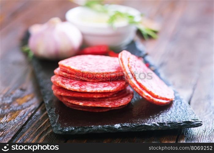salami on board and on a table