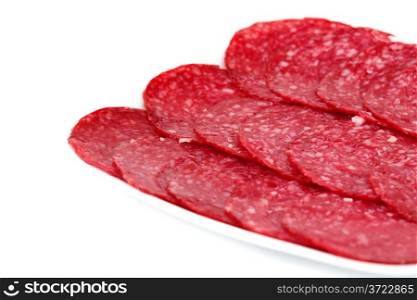 Salami on plate isolated on white background.