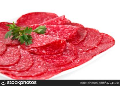 Salami on plate isolated on white background.