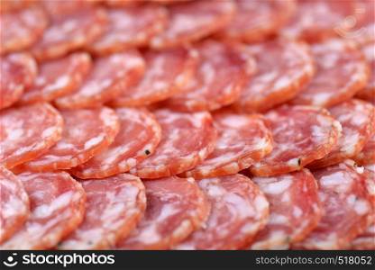 Salami sausage slices background. Close up. Slices of smoked sausage. Food background.