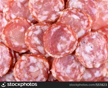 Salami sausage slices background. Close up. Slices of smoked sausage. Food background. Top view. Salami sausage slices background. Close up. Slices of smoked sausage. Food background.