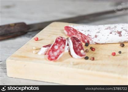 Salami sausage with homemade pepper on a cutting board