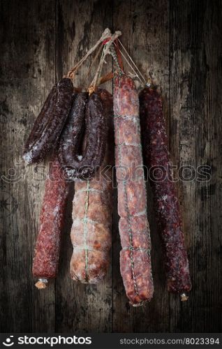 salami sausages. salami sausages on a wooden background