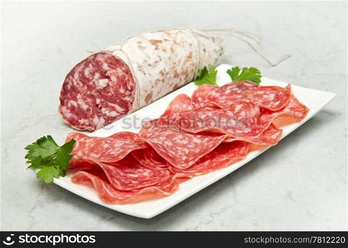 Salami sliced on marble table