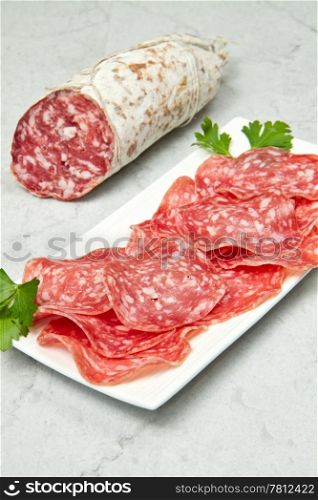 Salami sliced on marble table