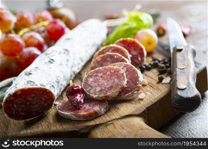 salami with spice on board, salami and fresh grape