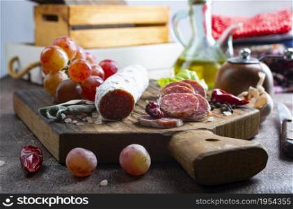 salami with spice on board, salami and fresh grape