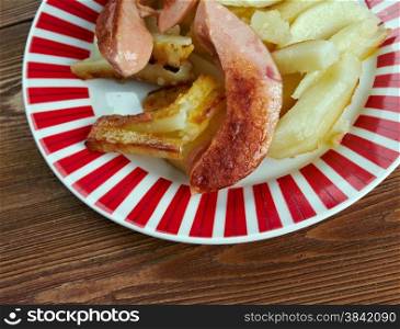 Salchipapas - fast food dish , street food throughout Latin America.consist of thinly sliced pan-fried beef sausages and French fries