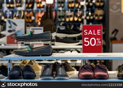 sale 50  off mock up advertise display frame setting over the men shoes shelf in the shopping department store for shopping, business fashion and advertisement concept