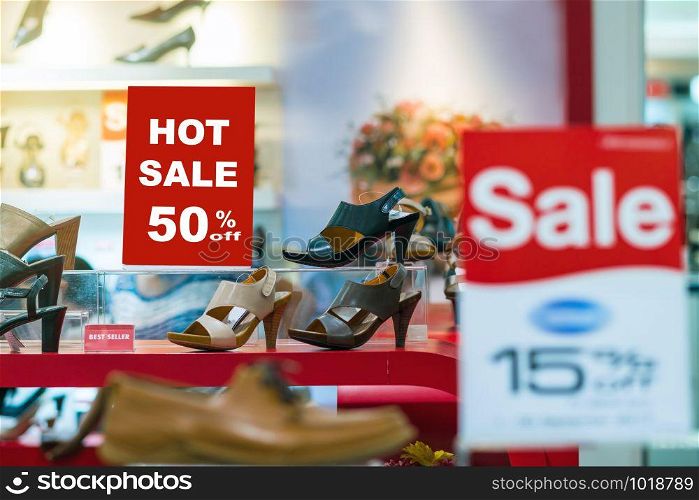 sale 50% off mock up advertise display frame setting over the women shoes shelf in the shopping department store for shopping, business fashion and advertisement concept