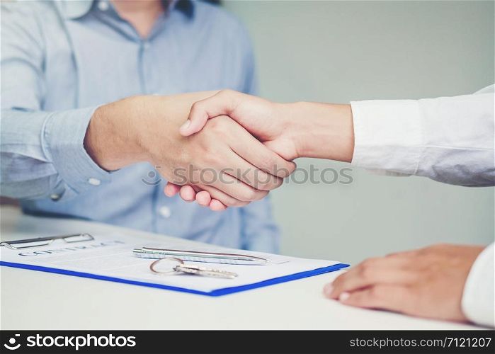 Sale agent and customer handshake and sign agreement contract, Insurance Home concept