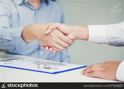 Sale agent and customer handshake and sign agreement contract, Insurance Home concept