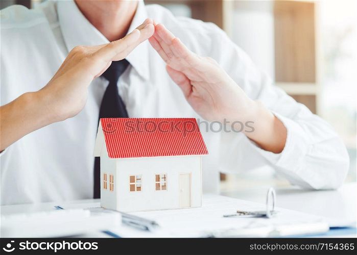 Sale agent giving house to customer and sign agreement contract, Insurance Home concept