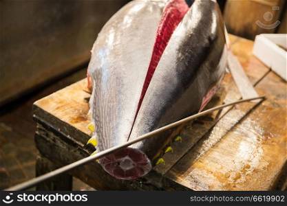 sale and food concept - fresh gutted tuna fish or seafood at japanese street market. fresh gutted tuna fish at japanese street market