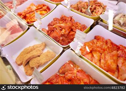 sale and food concept - marinated meat in bowls at grocery stall. marinated meat in bowls at grocery stall