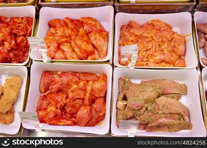 sale and food concept - marinated meat in bowls at grocery stall. marinated meat in bowls at grocery stall