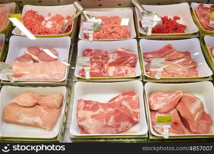 sale and food concept - meat in bowls at grocery stall. meat in bowls at grocery stall