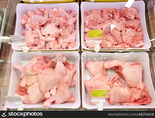 sale and food concept - poultry meat in bowls at grocery stall. poultry meat in bowls at grocery stall