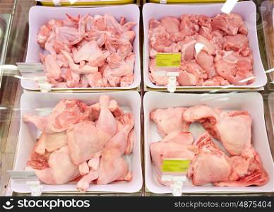 sale and food concept - poultry meat in bowls at grocery stall. poultry meat in bowls at grocery stall