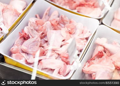sale and food concept - poultry meat in bowls at grocery stall. poultry meat in bowls at grocery stall. poultry meat in bowls at grocery stall