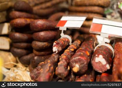 sale and food concept - smoked meat products at market or butcher shop. smoked meat products at market or butcher shop