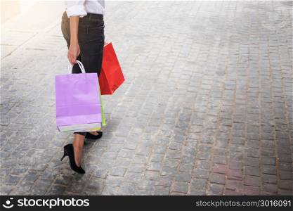sale and people concept smiling young woman with shopping bags having fun with their purchases In the shopping mall