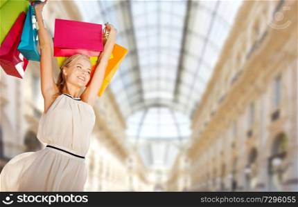 sale and people - woman with colorful shopping bags over mall background. woman with shopping bags over mall background