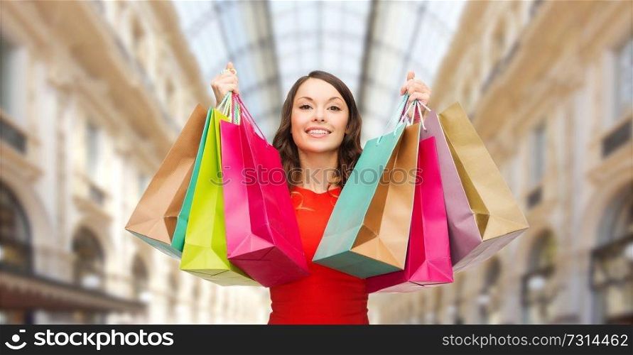 sale and people - woman with colorful shopping bags over mall background. woman with shopping bags over mall background