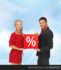 sale and shopping concept - smiling man and woman with percent sign