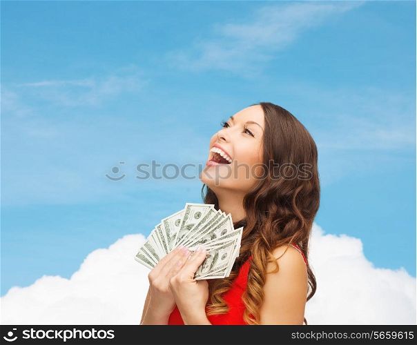sale, banking and people concept - smiling woman in red dress with us dollar money over blue sky with white cloud background