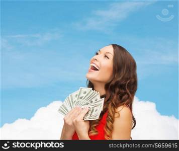 sale, banking and people concept - smiling woman in red dress with us dollar money over blue sky with white cloud background