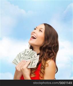 sale, banking and people concept - smiling woman in red dress with us dollar money over blue cloudy sky background