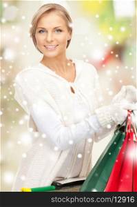 sale, christmas, x-mas and holidays concept - lovely woman with shopping bags