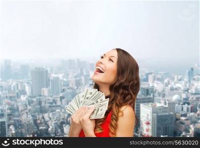 sale, city, estate, banking and people concept - smiling woman in red dress with us dollar money over cityscape background