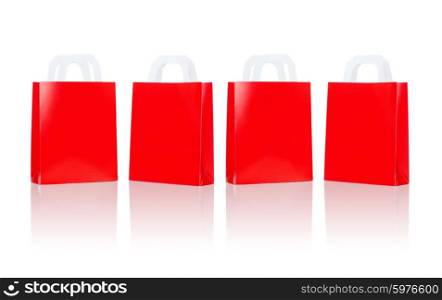 sale, consumerism, advertisement and retail concept - many blank red shopping bags