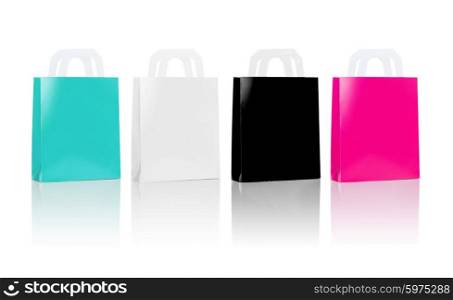 sale, consumerism, advertisement and retail concept - many blank shopping bags, blue white black pink color