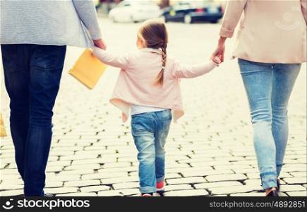 sale, consumerism and people concept - close up of happy family with little child and shopping bags in city