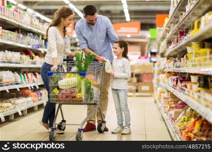 sale, consumerism and people concept - happy family with child and shopping cart buying food at grocery storeor supermarket