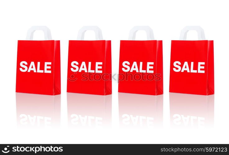 sale, consumerism, discount, advertisement and retail concept - many red shopping bags