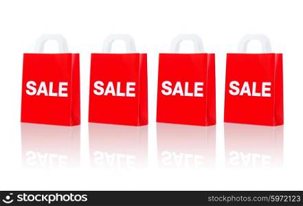 sale, consumerism, discount, advertisement and retail concept - many red shopping bags