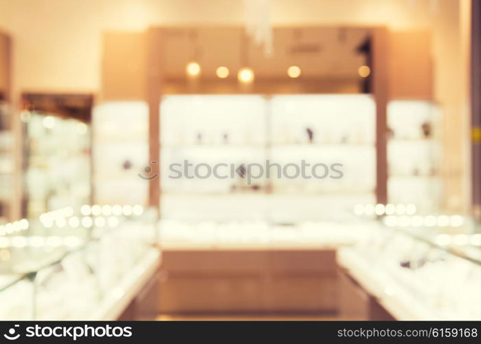 sale, consumerism, shopping and background concept - jewelry store blurred bokeh