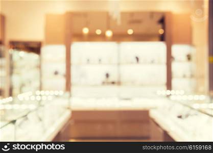 sale, consumerism, shopping and background concept - jewelry store blurred bokeh