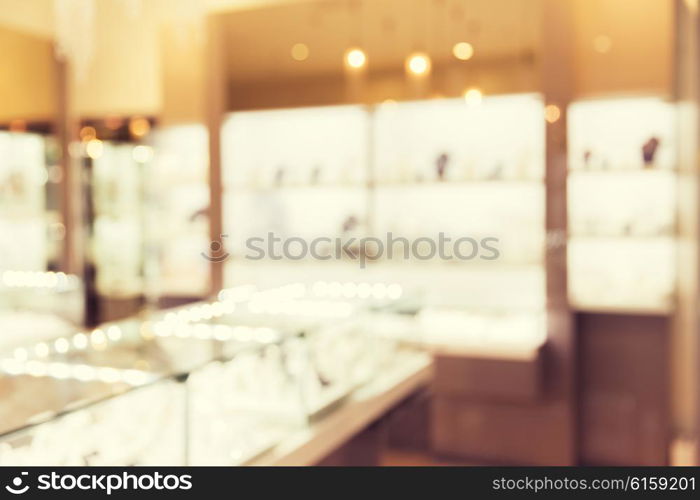 sale, consumerism, shopping and background concept - jewelry store blurred bokeh